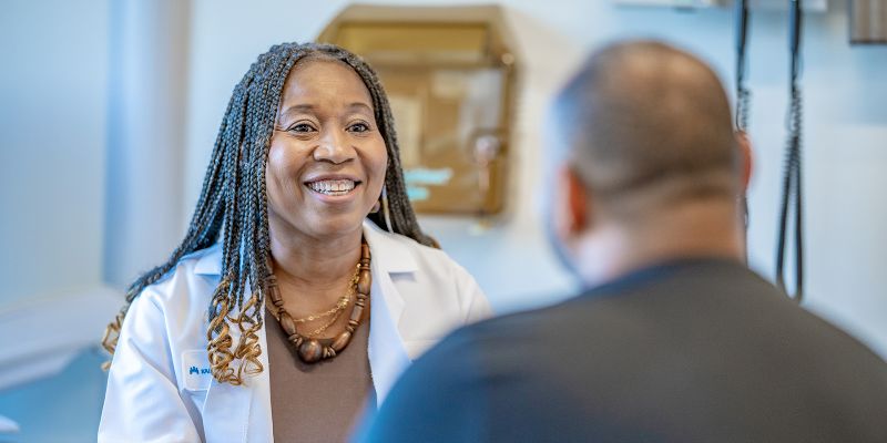 Jane Akpamgbo, MD, NWP Family Medicine physician meets with a patient